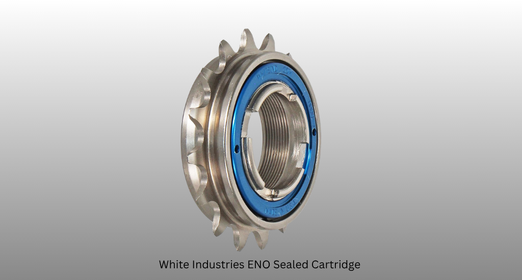 A high-performance White Industries ENO bicycle freewheel with a silver steel cog and blue sealed cartridge bearing, shown at an angle against a grey background.
