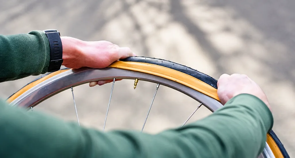 Removing a bike tire from the rim using a tire lever