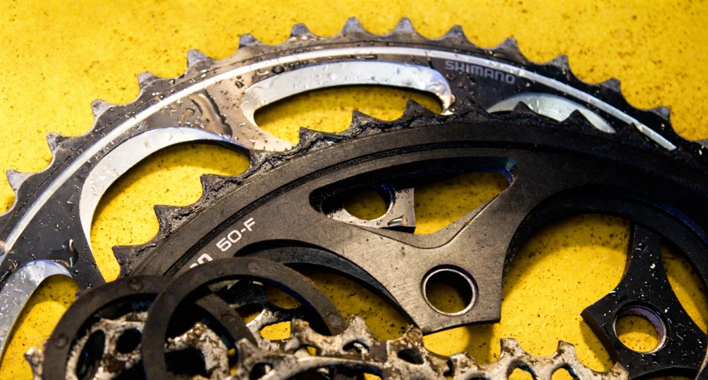 Worn bike drivetrain showing chain and gear wear